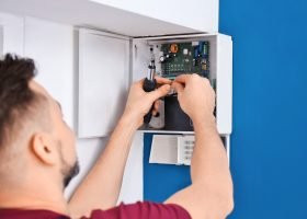 Electrician installing alarm system | Security System Repairs
